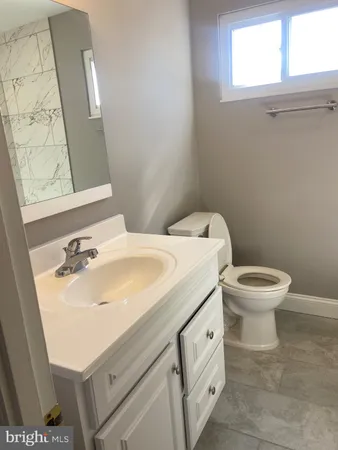 a bathroom with a toilet and a sink
