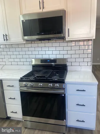 a view of a room with wooden floor and staircase