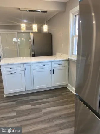 a bathroom with a sink a mirror and cabinets