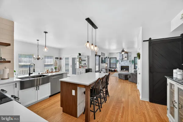 a kitchen with stainless steel appliances granite countertop a sink a stove and a refrigerator