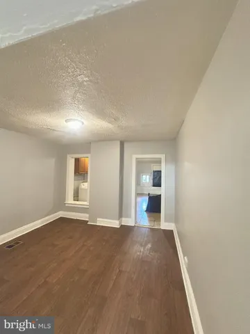 wooden floor in a room next to a window