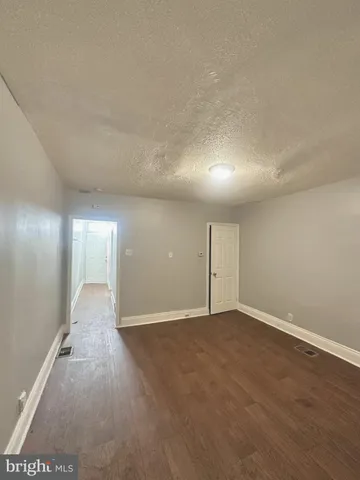 an empty room with windows and entrance