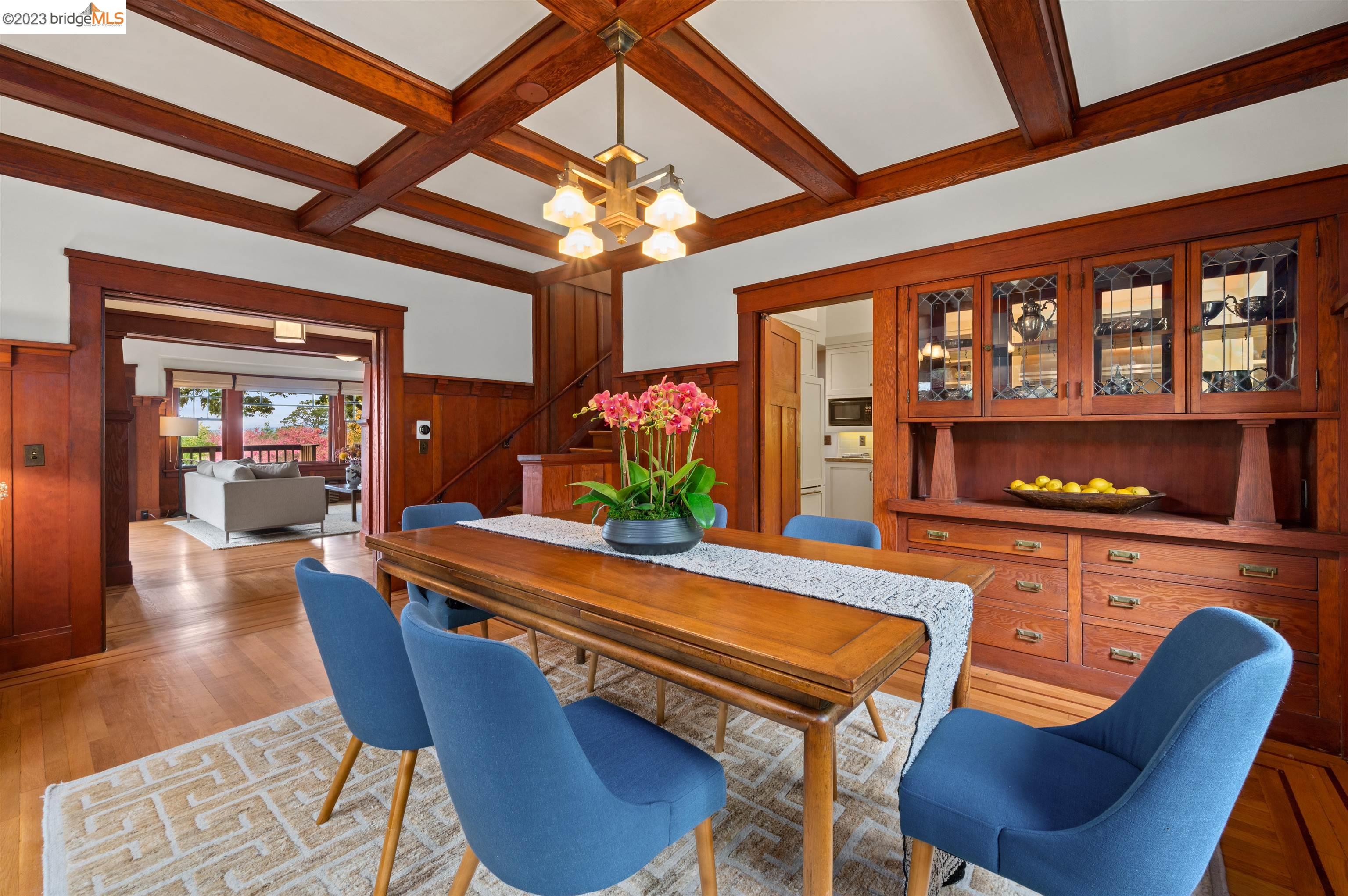 a dining room with furniture and a floor to ceiling window