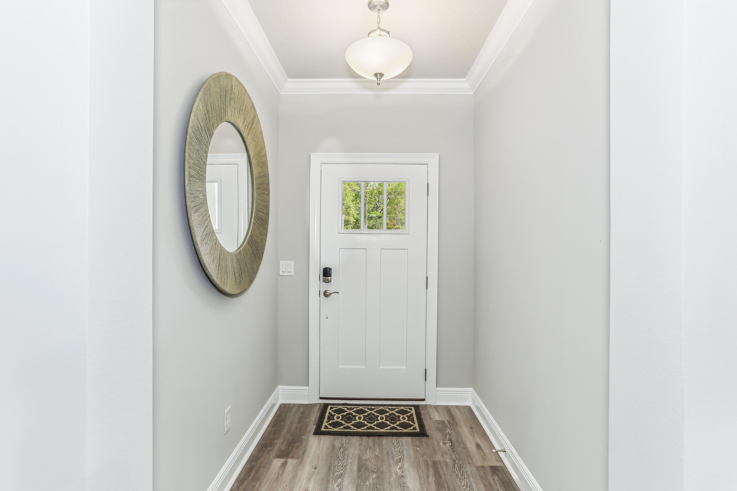 7568 Hatteras Drive Navarre, FL 32566 - Photo 13 of 44 a view of a livingroom with wooden floor and a window