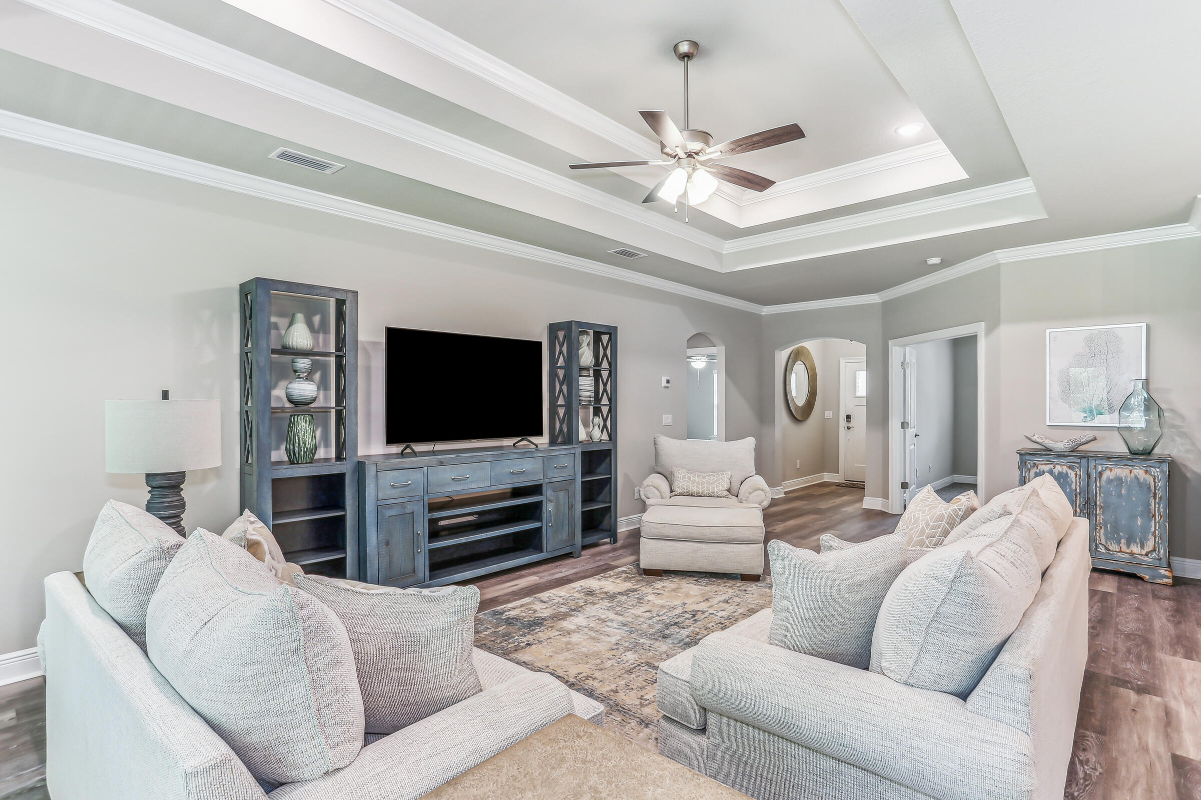7568 Hatteras Drive Navarre, FL 32566 - Photo 17 of 44 a living room with furniture and a flat screen tv