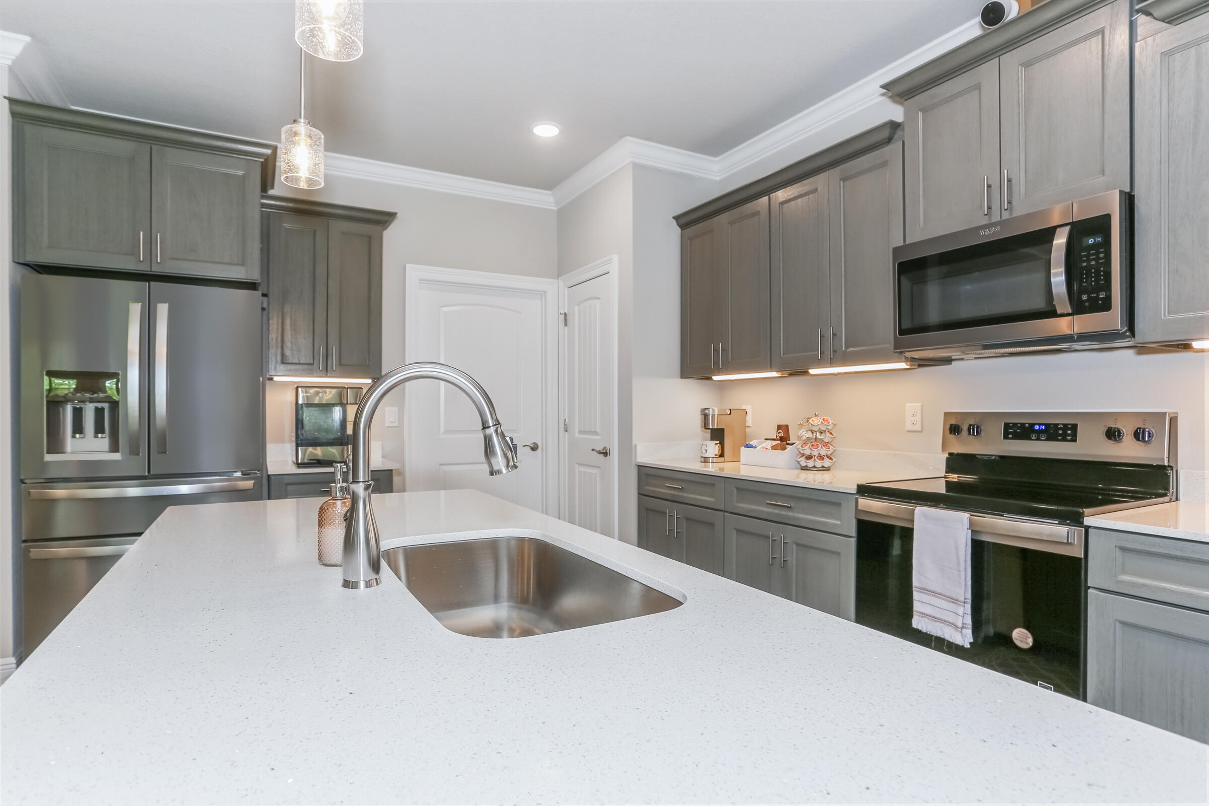 7568 Hatteras Drive Navarre, FL 32566 - Photo 22 of 44 a kitchen with stainless steel appliances granite countertop a stove top oven a sink and dishwasher