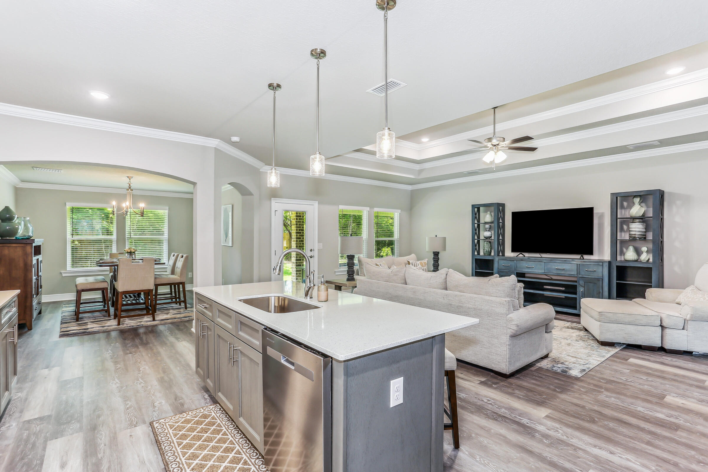 7568 Hatteras Drive Navarre, FL 32566 - Photo 23 of 44 a view of living room with furniture flat screen tv and floor to ceiling window