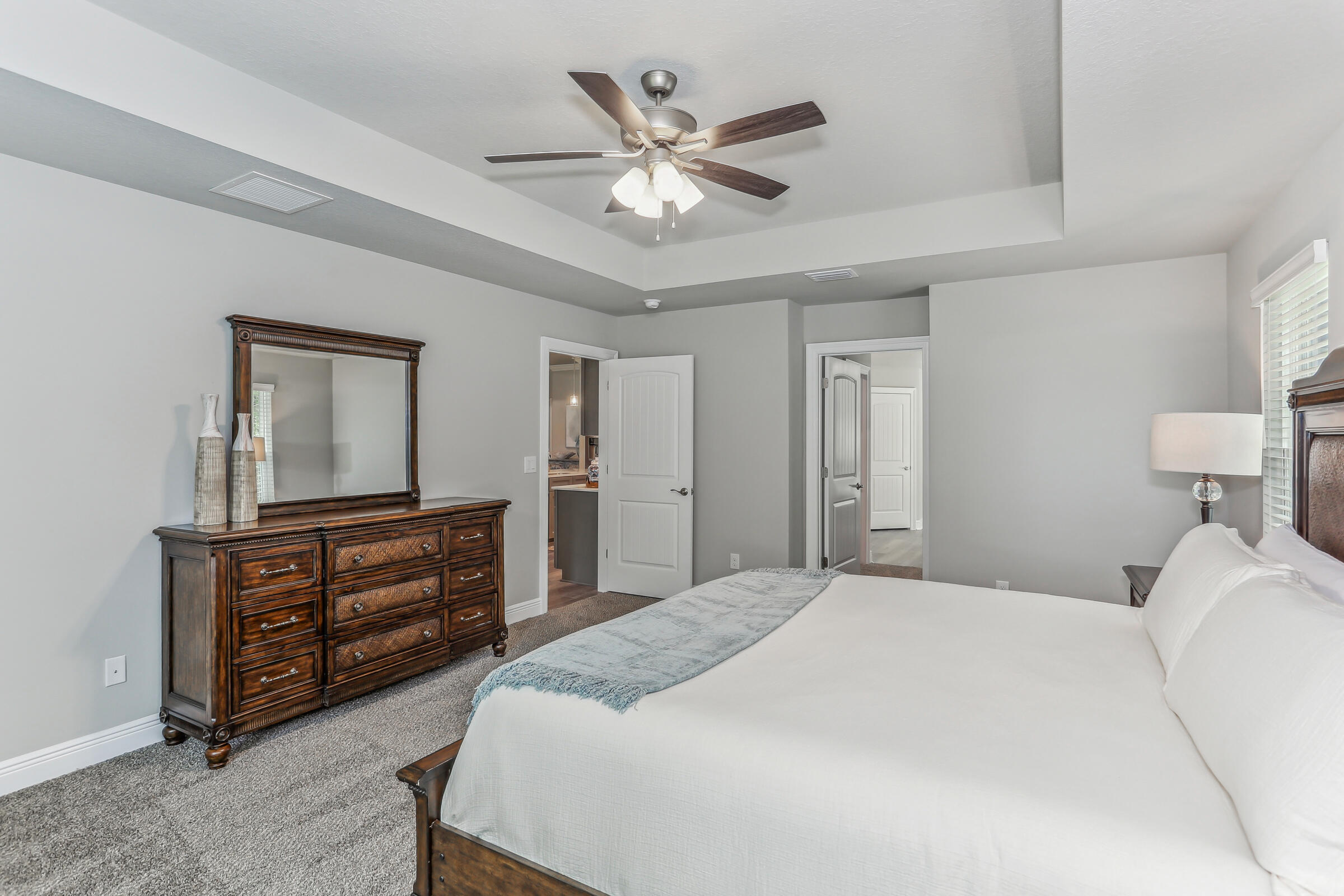 7568 Hatteras Drive Navarre, FL 32566 - Photo 28 of 44 a bedroom with a bed and ceiling fan