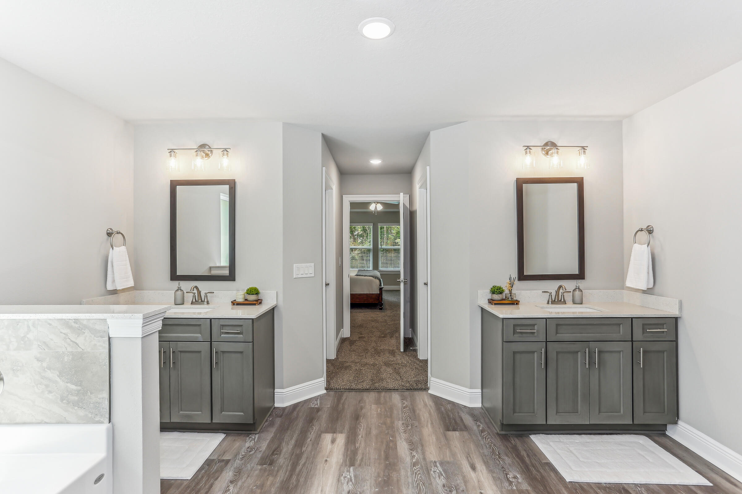7568 Hatteras Drive Navarre, FL 32566 - Photo 32 of 44 a spacious bathroom with a double vanity sink and mirror