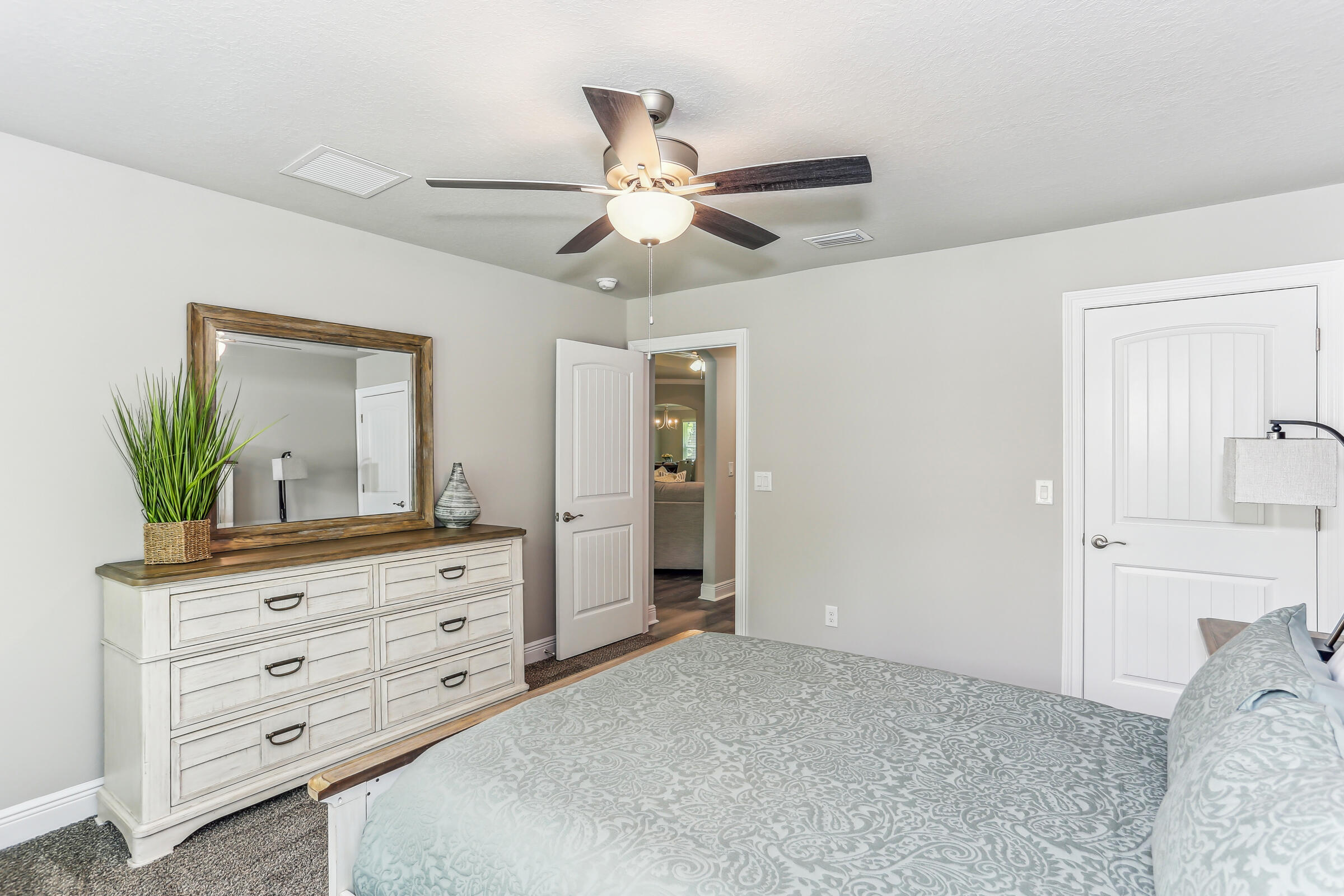7568 Hatteras Drive Navarre, FL 32566 - Photo 37 of 44 a bedroom with a bed and a dresser