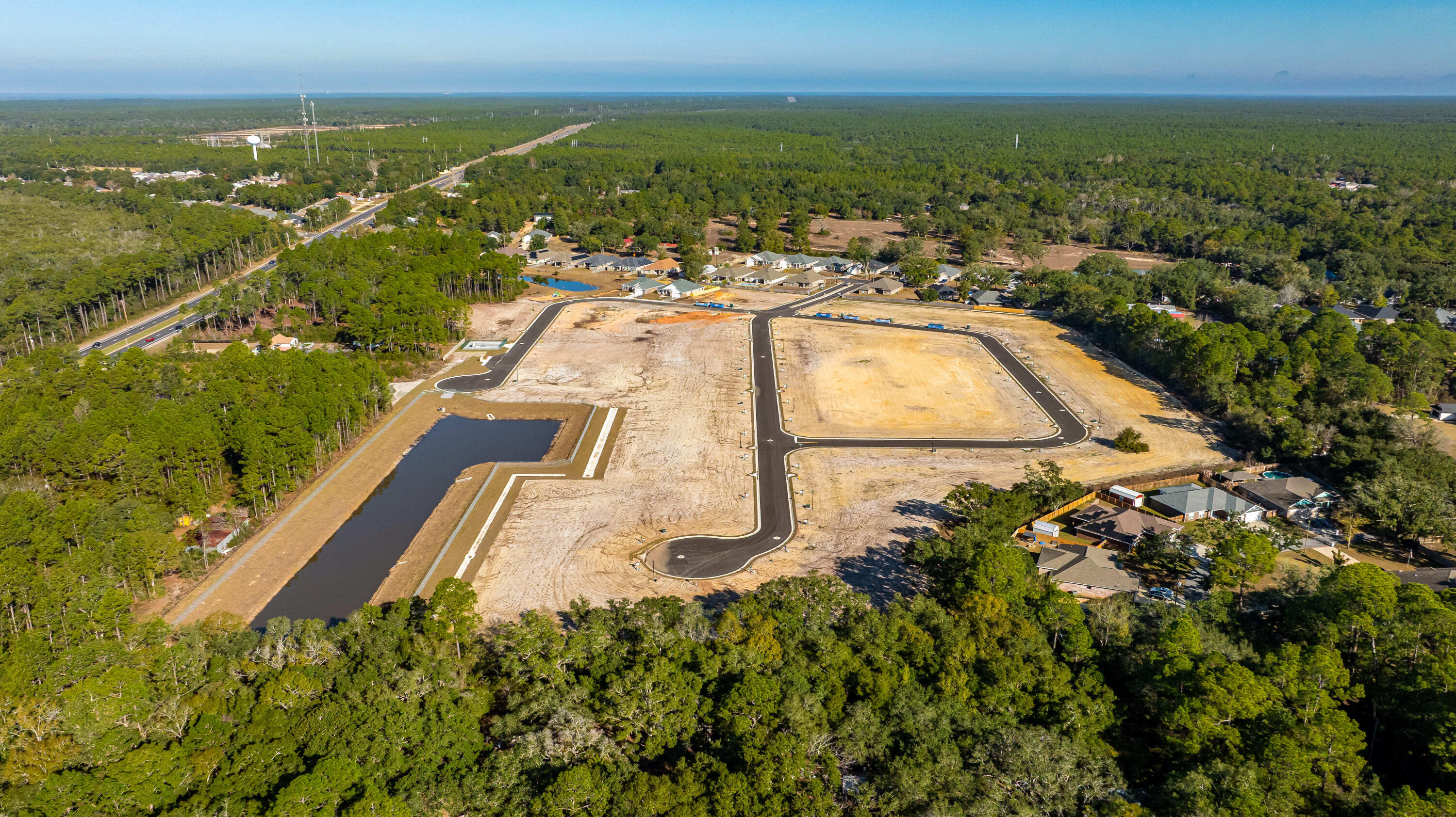7568 Hatteras Drive Navarre, FL 32566 - Photo 7 of 44 an aerial view of residential houses with outdoor space and river