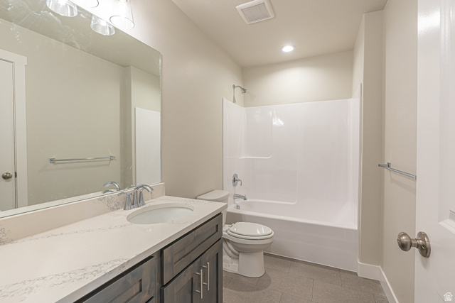 2249 South 1090 West, Unit 76 Nibley, UT 84321 - Photo 13 of 19 Bathroom featuring a vanity with a white countertop and undermount sink, dark wood-finish cabinetry, chrome fixtures, a full-width mirror, and a white tub/shower combination