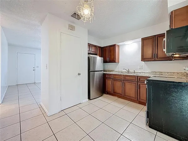 a kitchen with stainless steel appliances a refrigerator sink and microwave