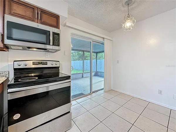 a view of kitchen with microwave stove and cabinets
