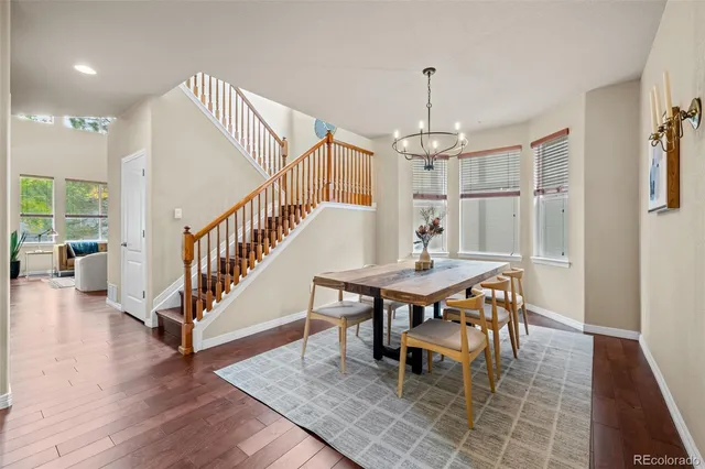 a dining room with furniture window and wooden floor