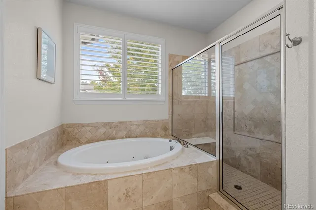 a bathroom with a bathtub and shower