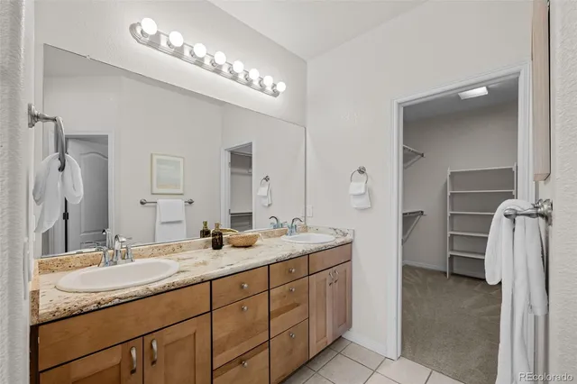 a bathroom with a double vanity sink and a mirror