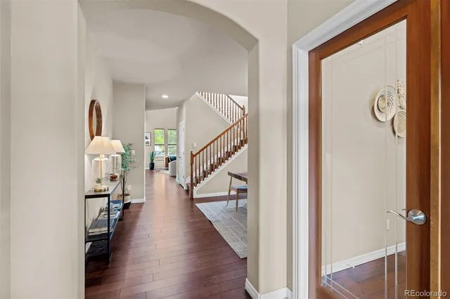 a view of entryway and hall with wooden floor