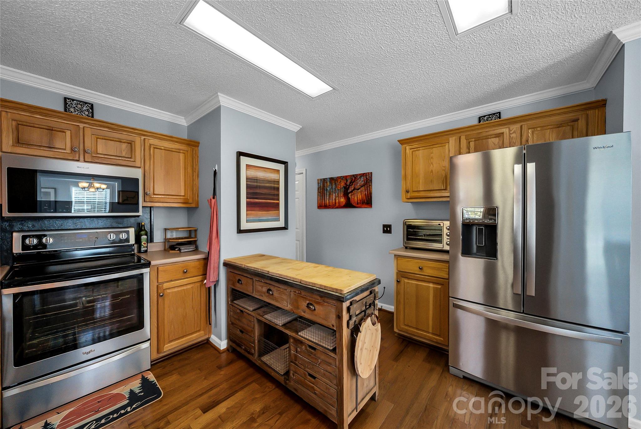 1273 State Rd S-20-317 Winnsboro, SC 29180 - Photo 19 of 48 a kitchen with stainless steel appliances and wooden cabinets