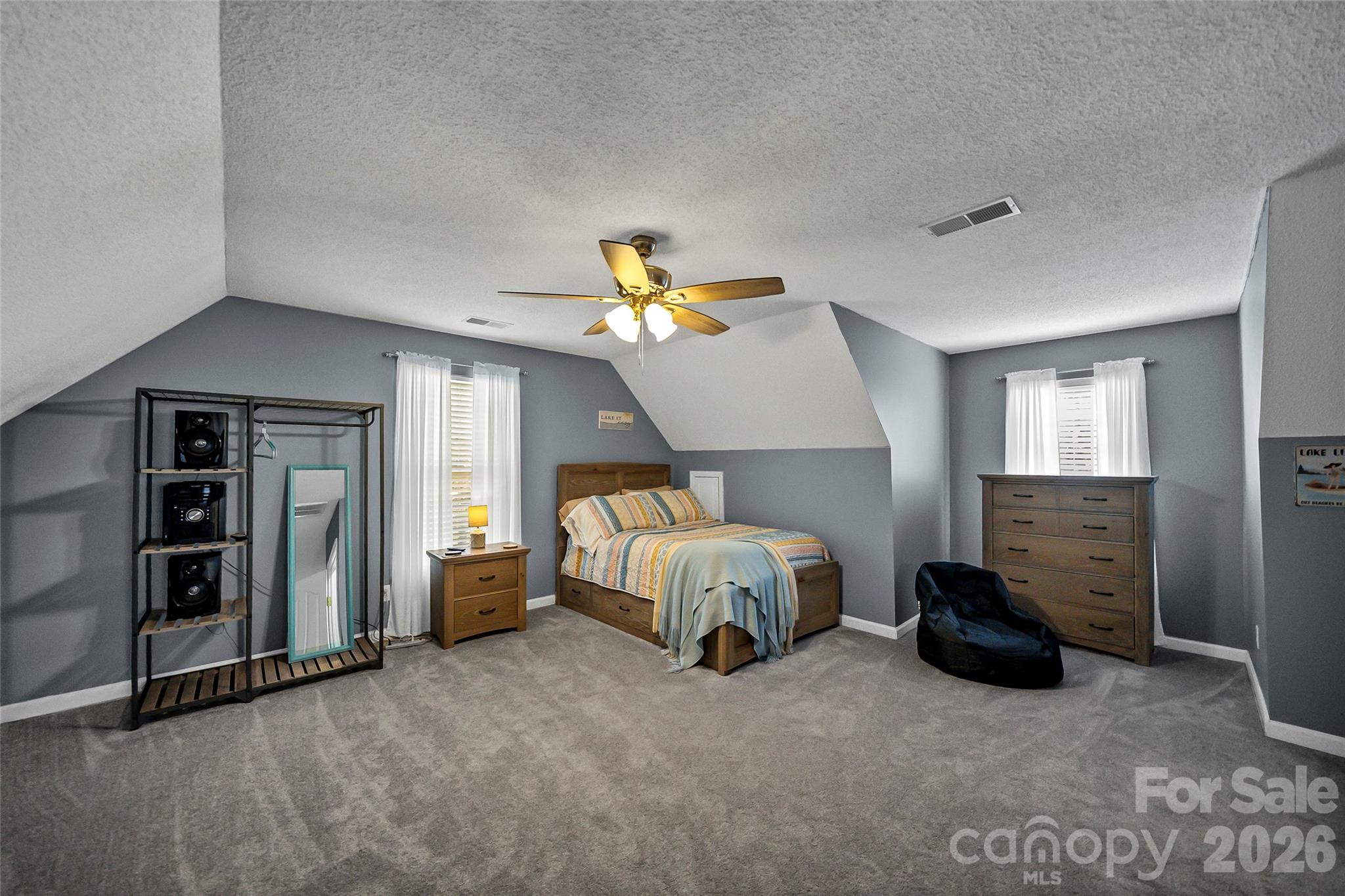 1273 State Rd S-20-317 Winnsboro, SC 29180 - Photo 34 of 48 a spacious bedroom with a bed and a chandelier