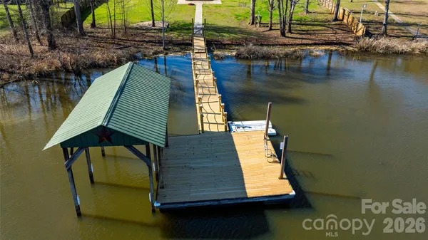 a swimming pool with outdoor seating and yard