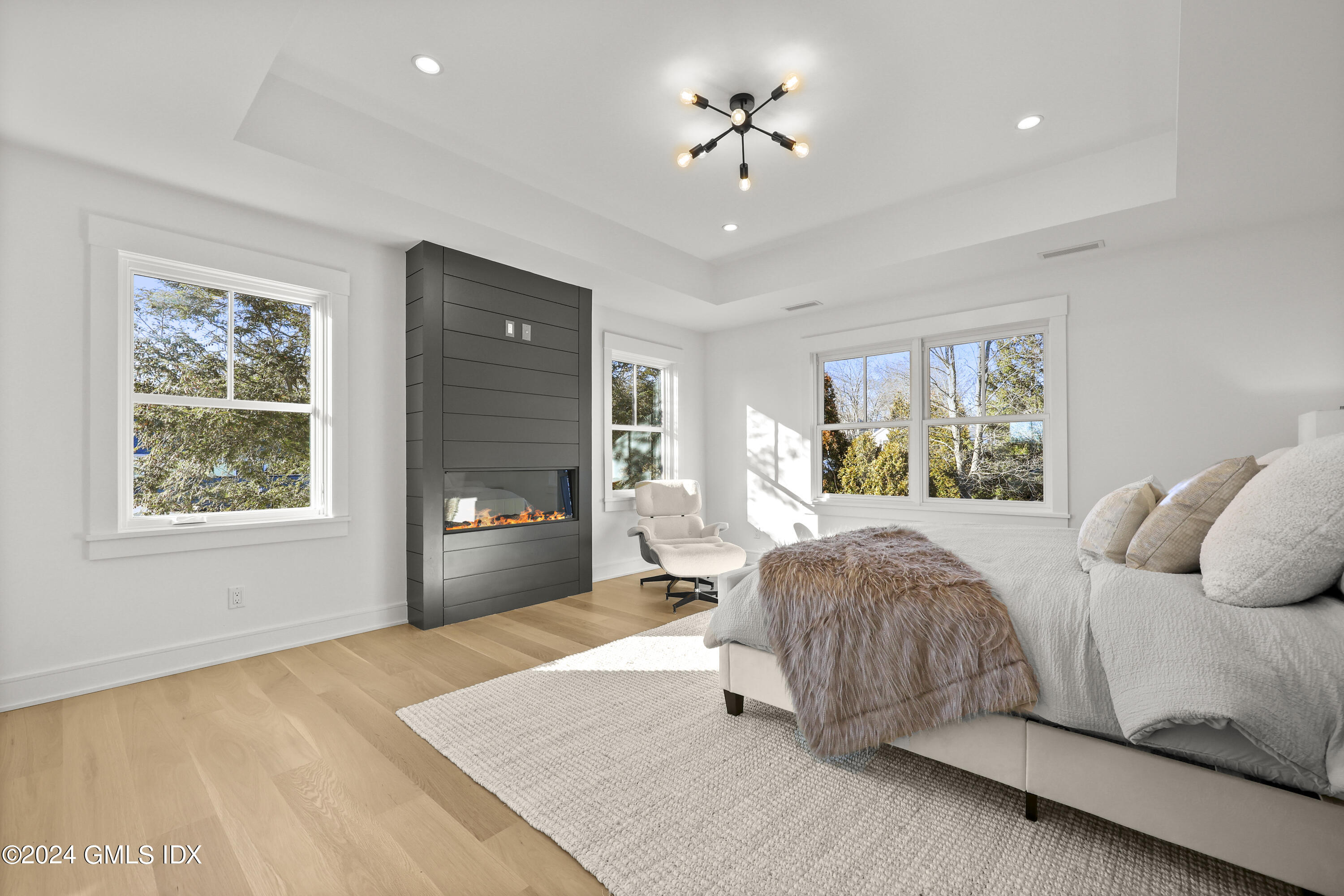5 Northridge Road Old Greenwich, CT 06870 - Photo 11 of 32 a bedroom with a bed and a chandelier