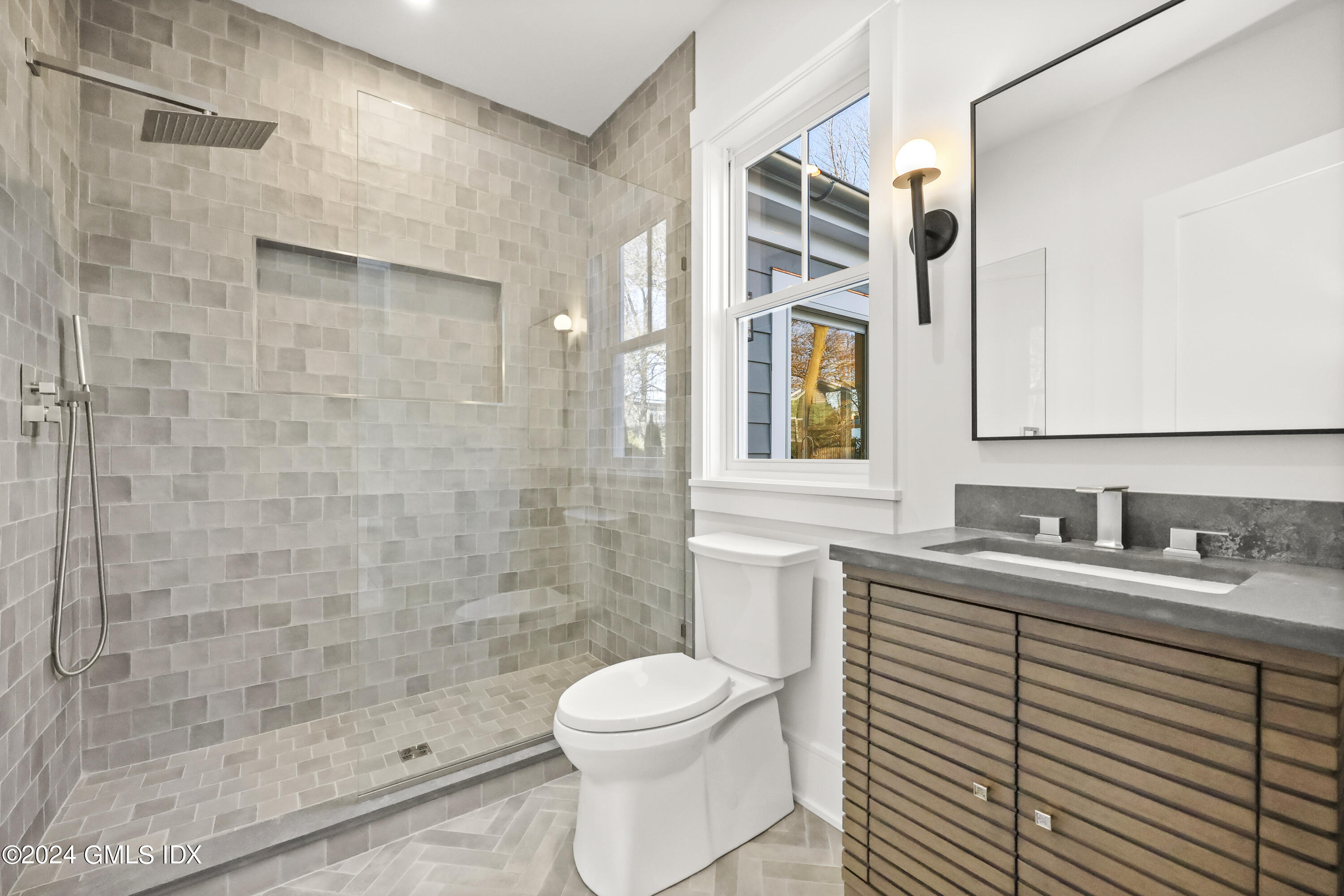 5 Northridge Road Old Greenwich, CT 06870 - Photo 20 of 32 a bathroom with a granite countertop sink toilet a mirror and shower