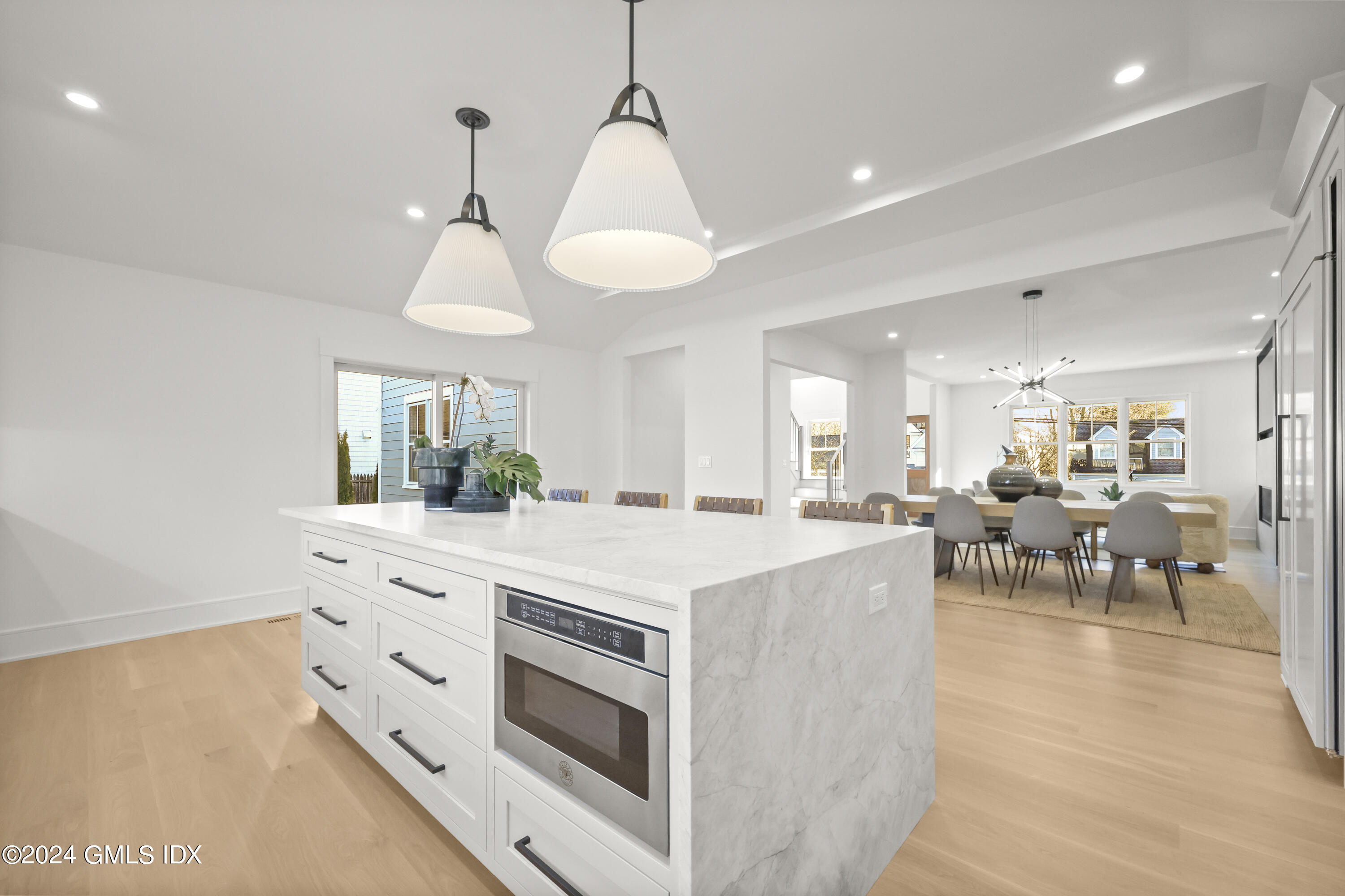 5 Northridge Road Old Greenwich, CT 06870 - Photo 7 of 32 a kitchen with a stove a chandelier and a view of living room
