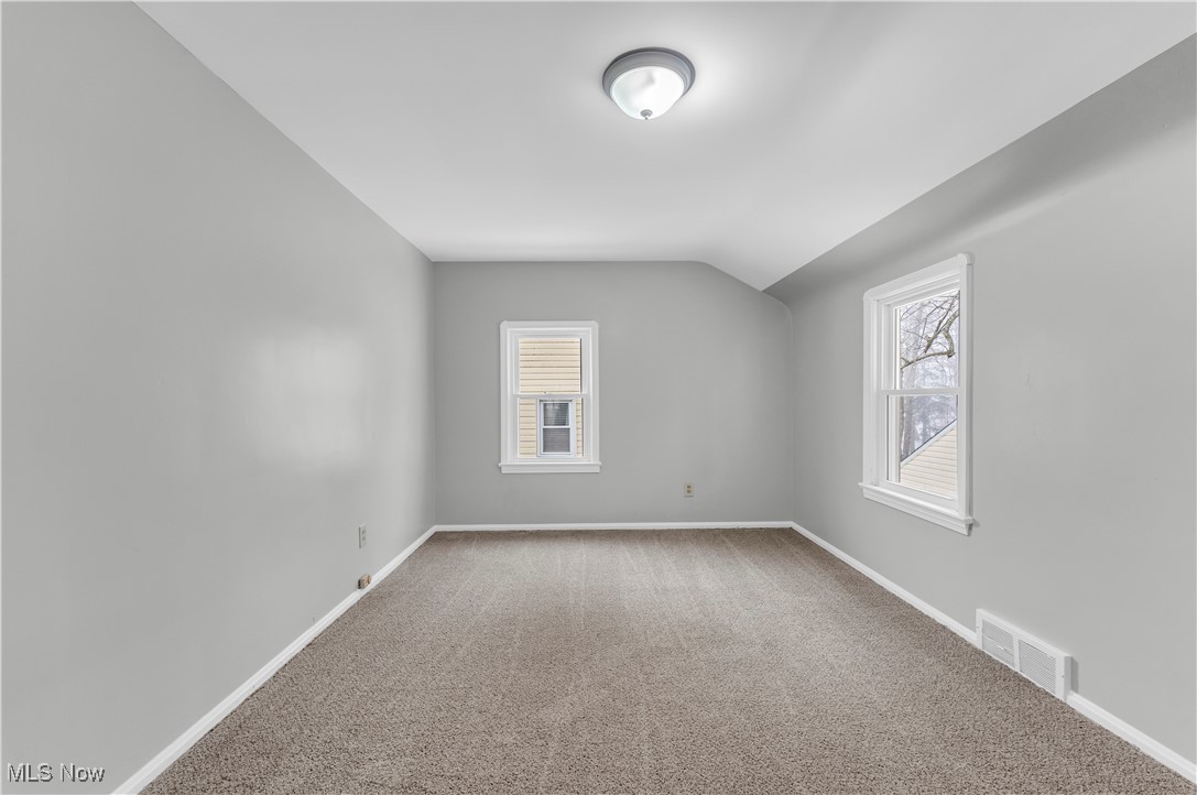 4693 Liberty Road South Euclid, OH 44121 - Photo 20 of 33 Unfurnished room with carpet, lofted ceiling, and plenty of natural light