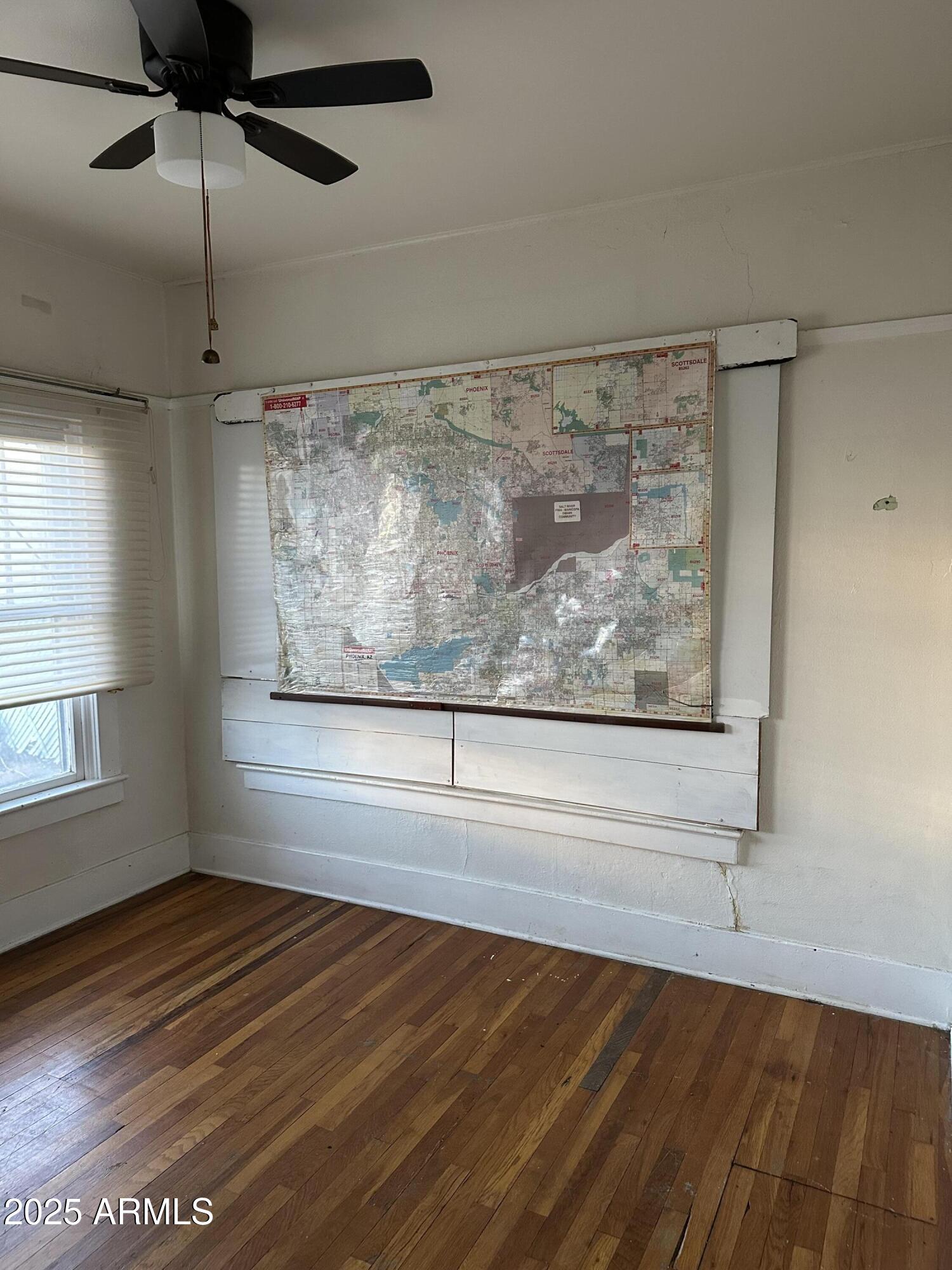 1008 North 27th Street Phoenix, AZ 85008 - Photo 7 of 15 a view of a room with wooden floor fan and windows