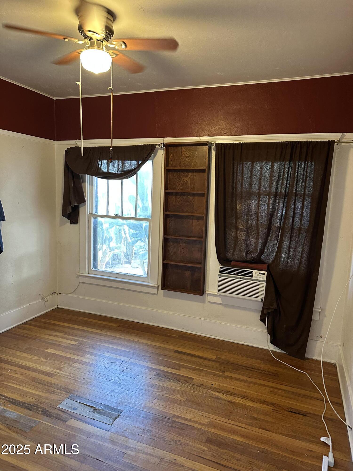 1008 North 27th Street Phoenix, AZ 85008 - Photo 8 of 15 a view of a room with wooden floor fan and window