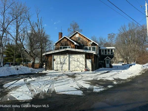 a view of a house with snow on the side of it