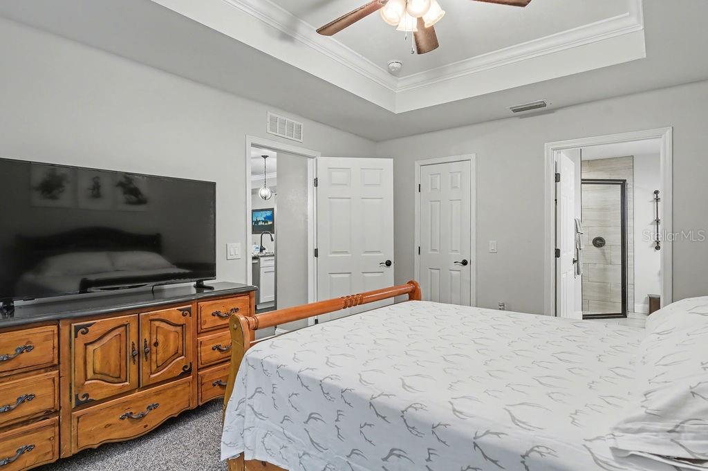 8291 Northeast 118th Terrace Bronson, FL 32621 - Photo 18 of 25 a bedroom with a bed and flat screen tv