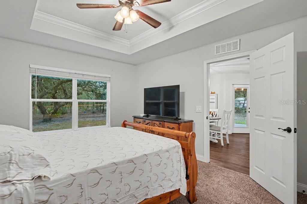 8291 Northeast 118th Terrace Bronson, FL 32621 - Photo 19 of 25 a bedroom with a bed and a flat screen tv