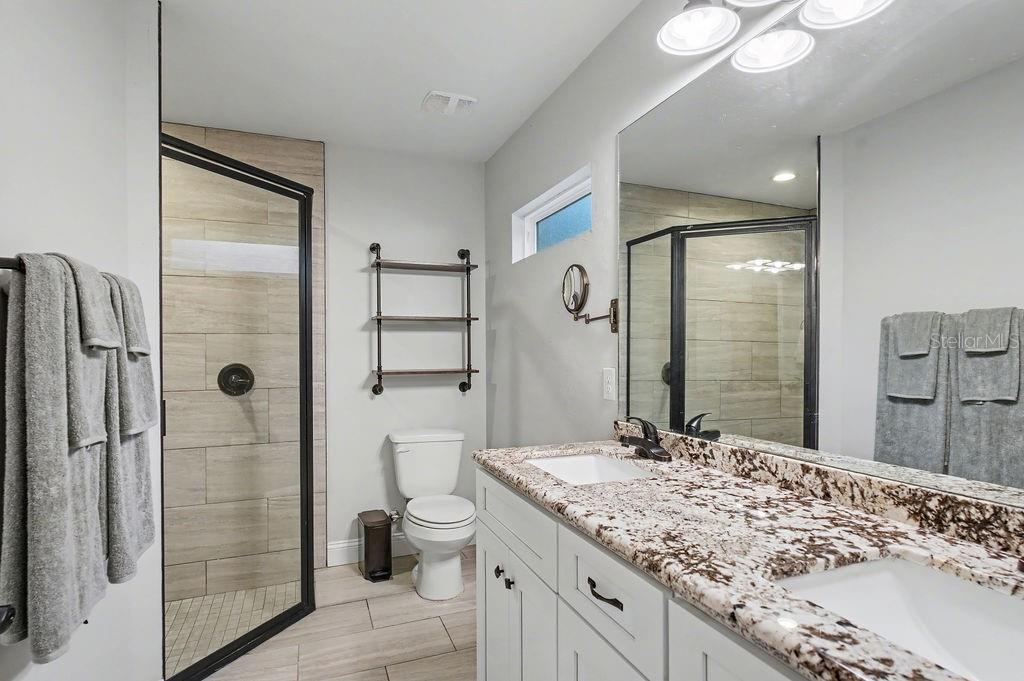 8291 Northeast 118th Terrace Bronson, FL 32621 - Photo 20 of 25 a bathroom with a granite countertop sink toilet and shower