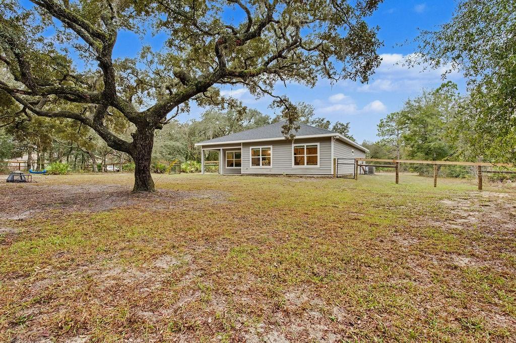 8291 Northeast 118th Terrace Bronson, FL 32621 - Photo 24 of 25 a view of a house with a yard