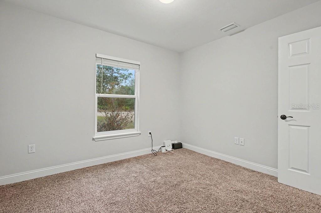 8291 Northeast 118th Terrace Bronson, FL 32621 - Photo 7 of 25 an empty room with a window