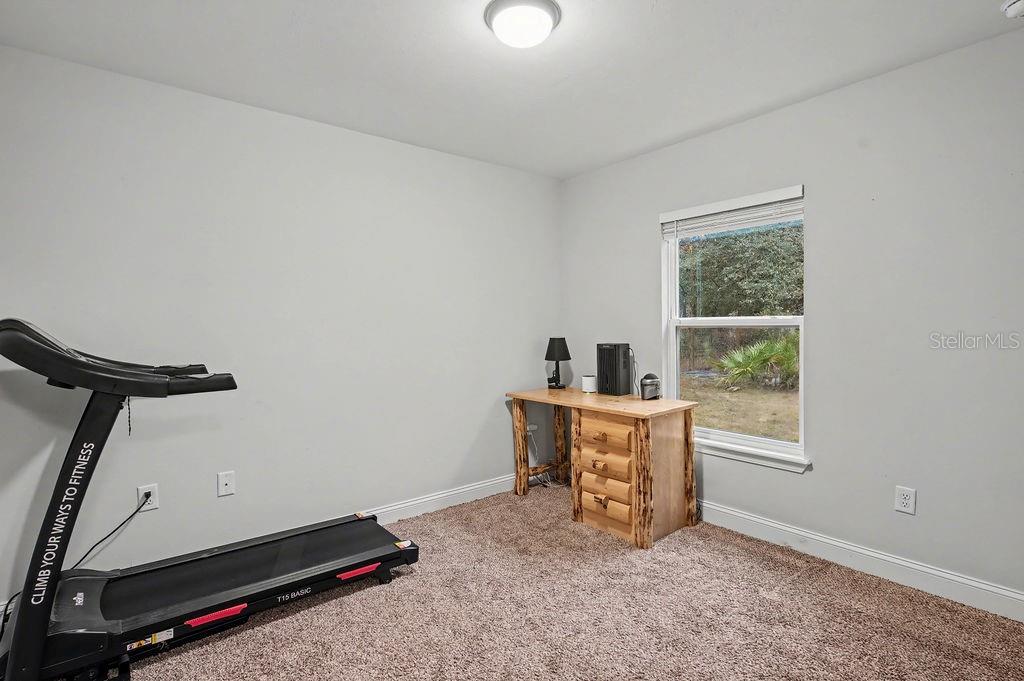 8291 Northeast 118th Terrace Bronson, FL 32621 - Photo 10 of 25 a room with gym equipment and a window