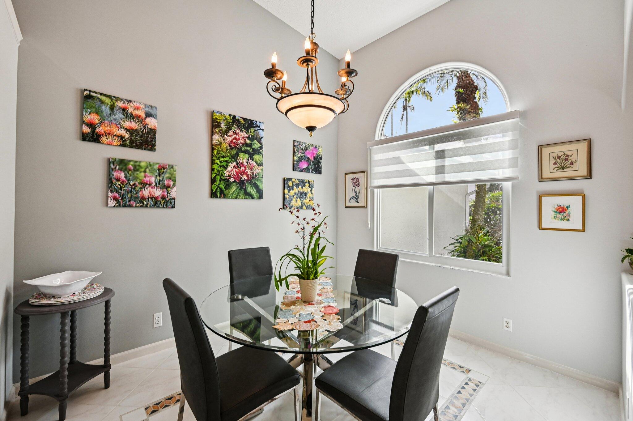 231 Sparrow Point Jupiter, FL 33458 - Photo 18 of 65 a view of a dining room with furniture a chandelier and wooden floor