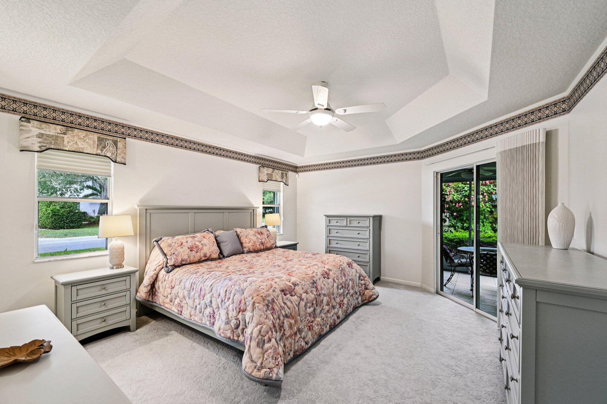 231 Sparrow Point Jupiter, FL 33458 - Photo 26 of 65 a bedroom with a large bed and a chandelier