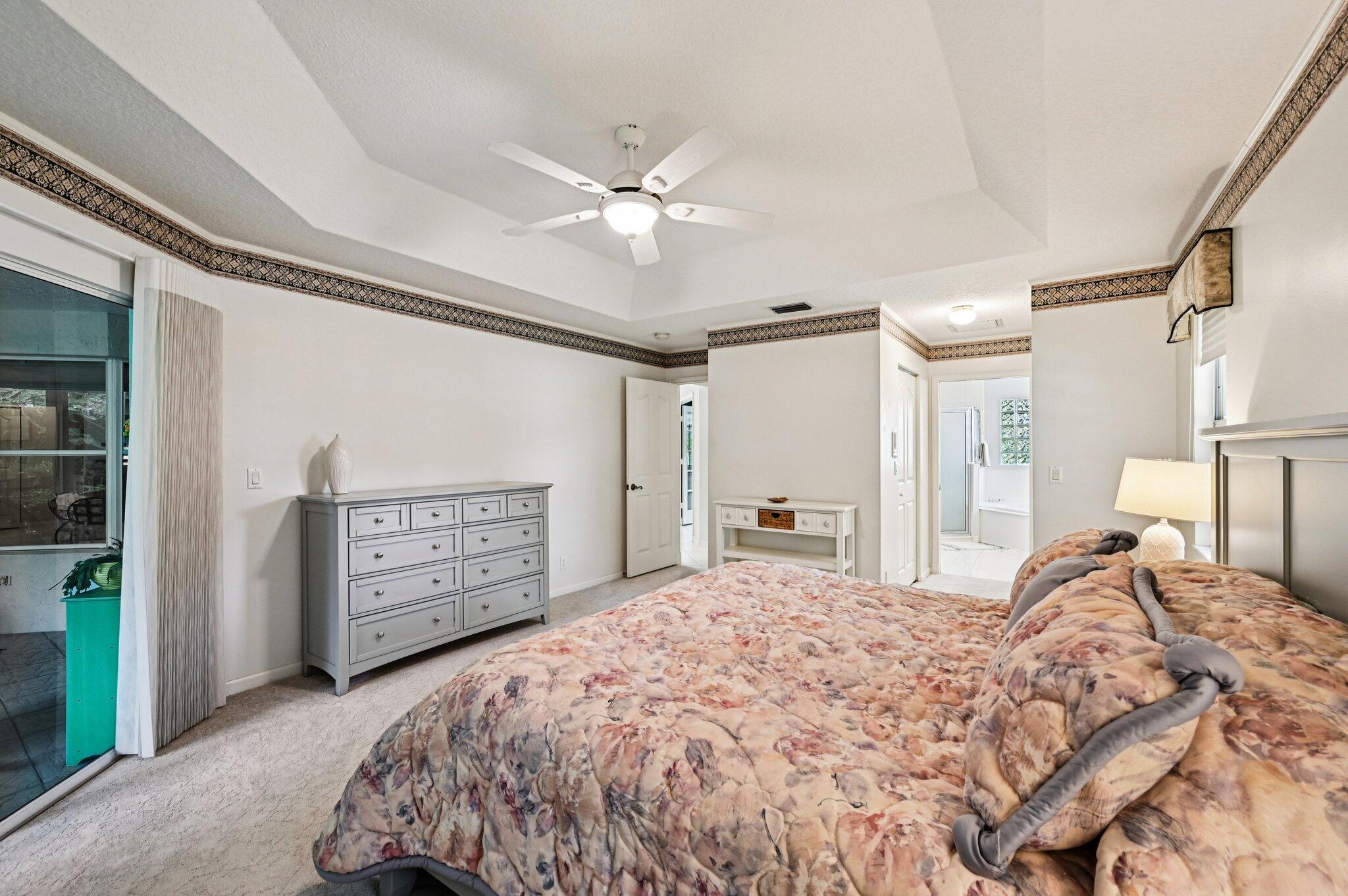 231 Sparrow Point Jupiter, FL 33458 - Photo 27 of 65 a bed room with a bed and a ceiling fan