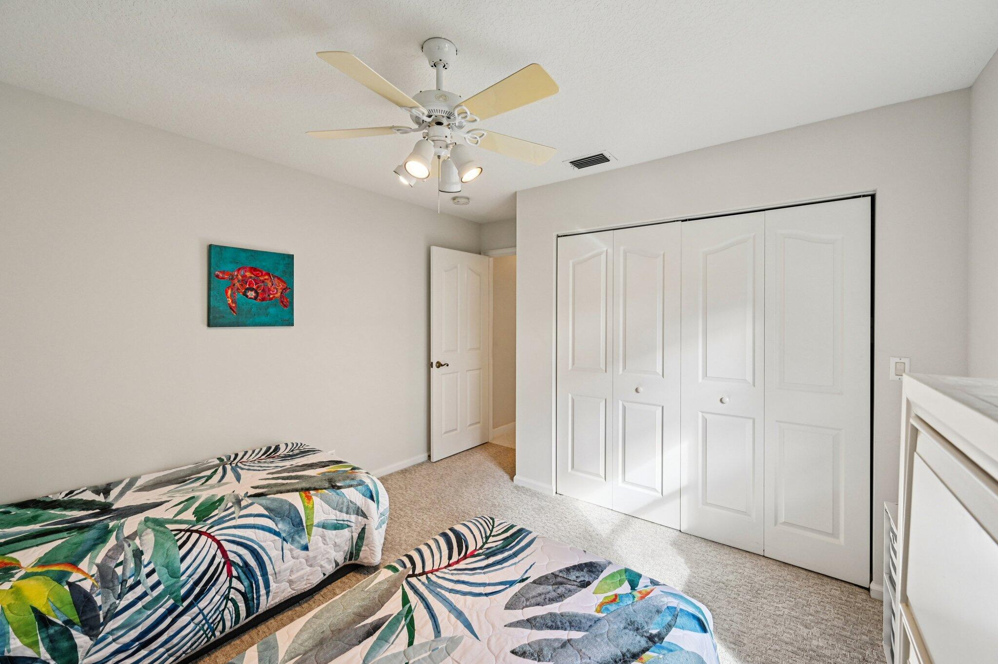 231 Sparrow Point Jupiter, FL 33458 - Photo 34 of 65 a bedroom with a bed and a chandelier