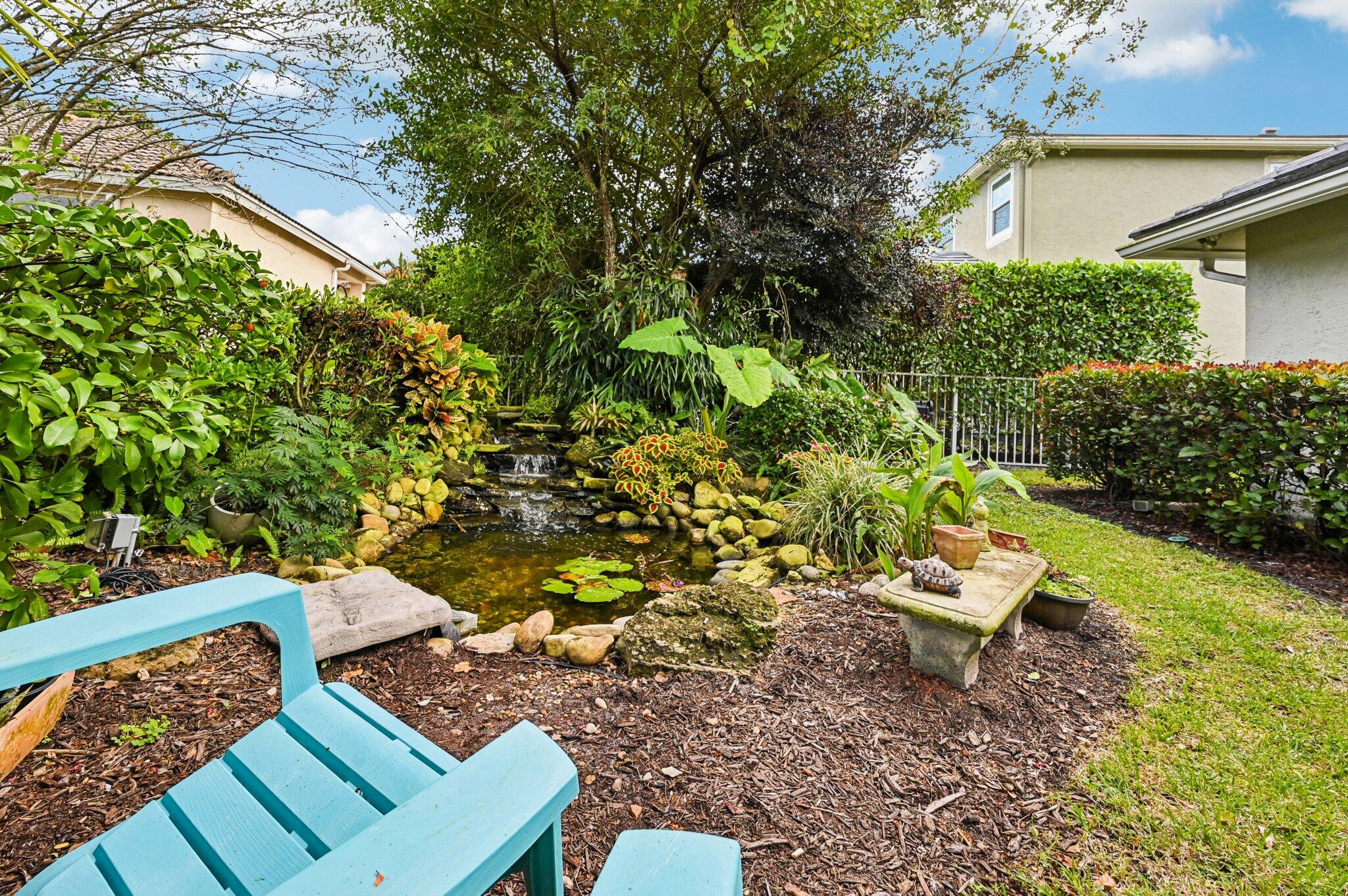 231 Sparrow Point Jupiter, FL 33458 - Photo 38 of 65 a view of a backyard with chairs and a flower pot