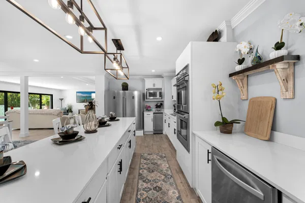 a living room with furniture dining table and a chandelier