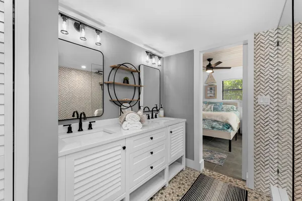 a bathroom with a sink a mirror and a shower