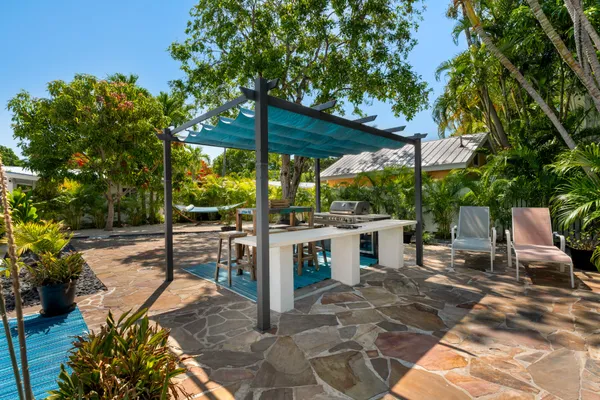 a view of a house with backyard and sitting area