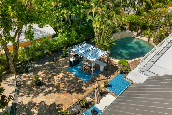 a view of a house with a tree in the background