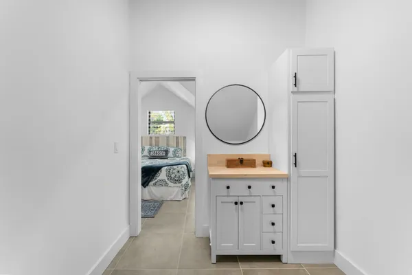 a front view of a house with a garden and trees