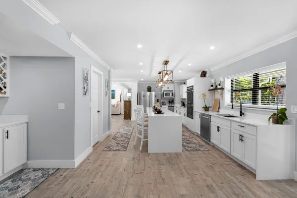 a kitchen with cabinets and chairs in it