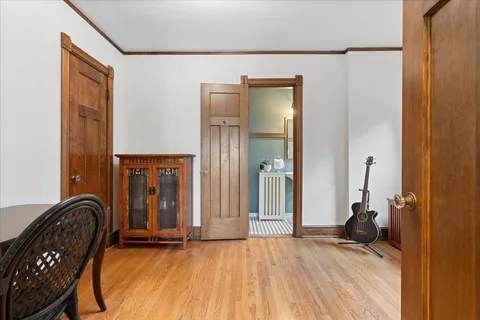 a view of a hallway with wooden floor and furniture